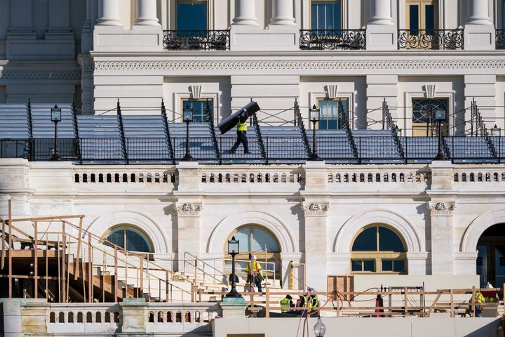 Construction crews, seen in November, work on the platforms where the president-elect will take the oath of office at the Capitol.