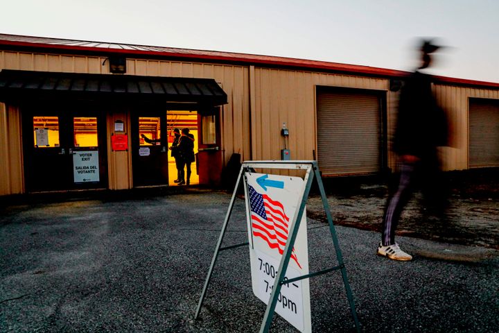 Voters enter and exit a polling station at the Gwinnett County Fairgrounds on January 5, 2021 in Lawrenceville, Georgia. (Photo by SANDY HUFFAKER/AFP via Getty Images)