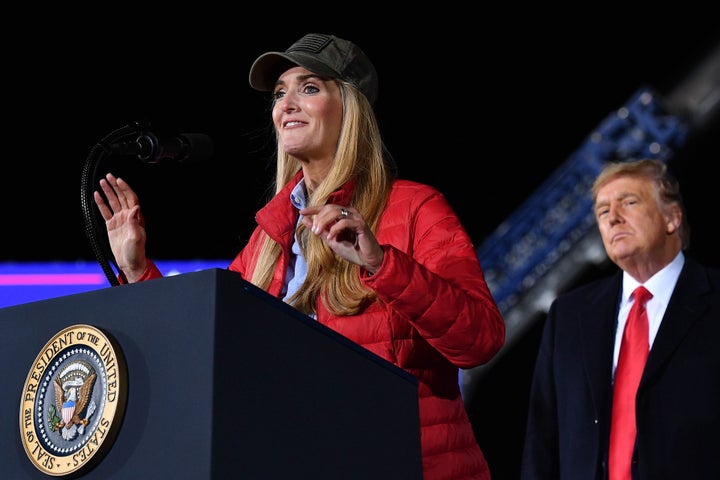 Republican incumbent senator Kelly Loeffler speaks as President Donald Trump listens during a rally in support of Republican incumbent senators Kelly Loeffler and David Perdue ahead of Senate runoff at Dalton Regional Airport, Georgia on January 4, 2021. (Photo by MANDEL NGAN/AFP via Getty Images)