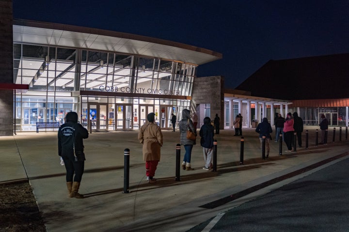 Voters stand in line before the doors open at Cobb County Community Center on January 5, 2021 in Atlanta, Georgia. (Photo by Megan Varner/Getty Images)