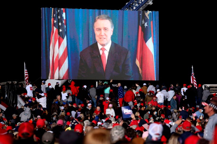 Republican incumbent senator David Perdue speaks via video monitor during a rally ahead of a Senate runoff in Dalton, Georgia on January 4, 2021. (Photo by SANDY HUFFAKER/AFP via Getty Images)