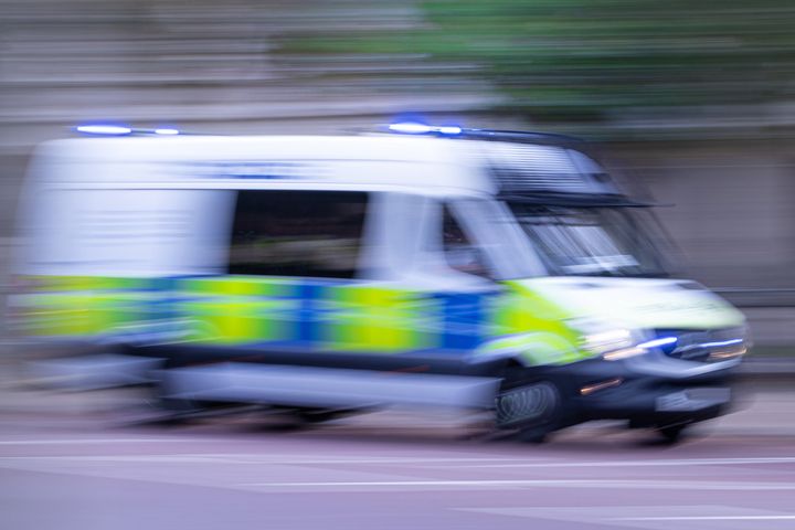 Abstract, motion blurred Metropolitan police van speeding along the Mall in London, UK