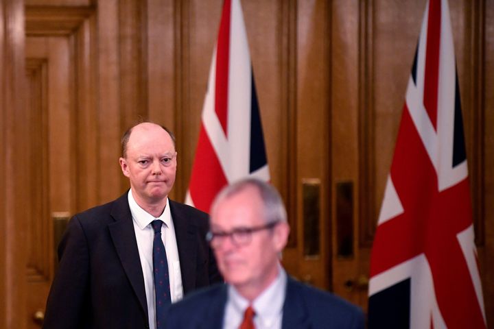 Chief Medical Officer for England Chris Whitty (L) and Chief Scientific Adviser Patrick Vallance arrive to attend a virtual press conference inside 10 Downing Street