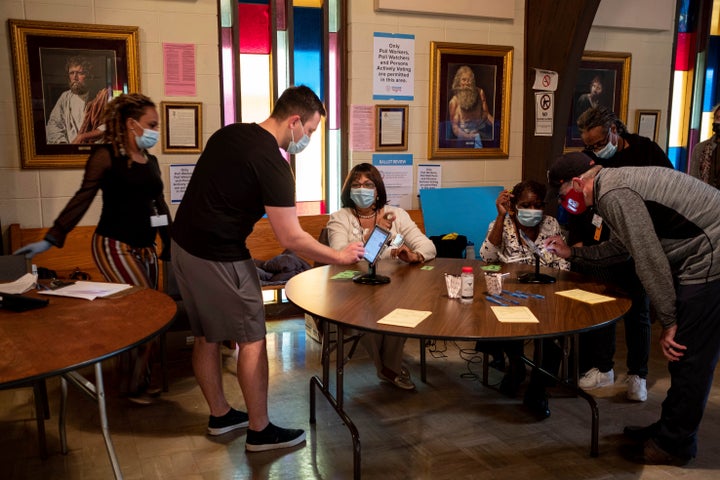 People sign in to vote in the Senate runoff elections at the Lawrenceville Road United Methodist Church in Tucker, Georgia, o