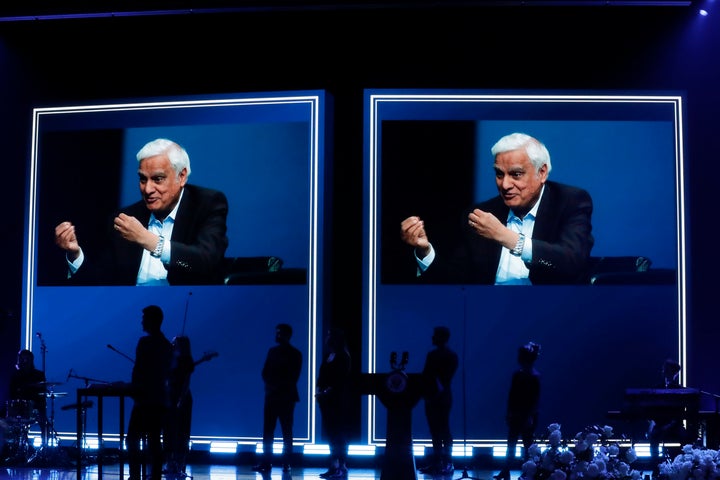 In this May 29, 2020 file photo, images of Ravi Zacharias are displayed in the Passion City Church during a memorial service