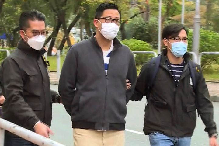 In this image taken from a video, Hong Kong's Democratic Party member and former lawmaker Lam Cheuk-ting, center, is arrested by police officers at his home in Hong Kong, on Jan. 6, 2021. 