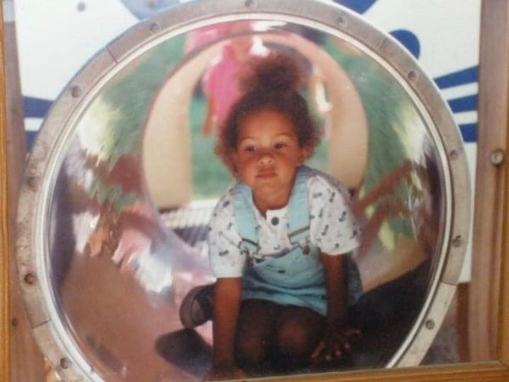 The author at age 4, when her hair finally grew long enough to assemble into some sort of bun (which she viewed as "a thrilli