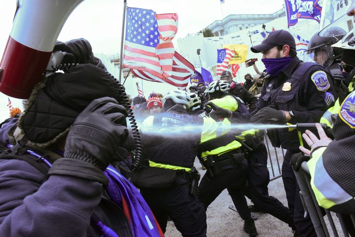 Supporters of Donald Trump clash with police officers in front of the US Capitol Building in Washington.