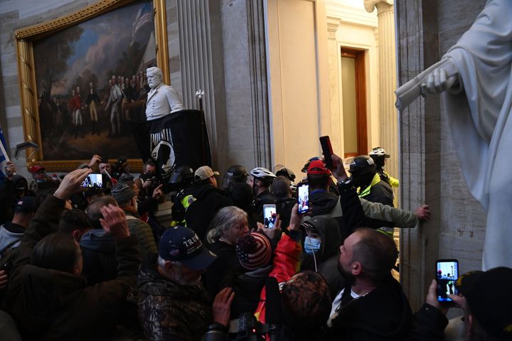 Supporters of US President Donald Trump protest in the US Capitol's Rotunda on January 6, 2021, in Washington, DC. - Demonstrators breeched security and entered the Capitol as Congress debated the a 2020 presidential election Electoral Vote Certification. (Photo by Saul LOEB / AFP) (Photo by SAUL LOEB/AFP via Getty Images)