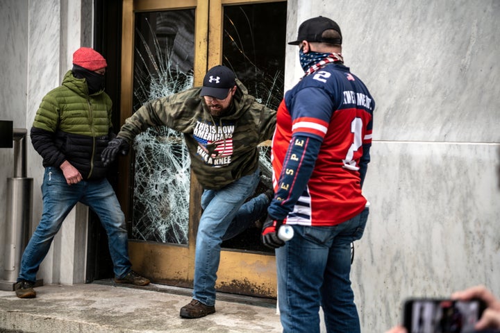 Far-right protesters break the door to the Capitol building during a protest against restrictions to prevent the spread of coronavirus disease (COVID-19) in Salem, Oregon, U.S., December 21, 2020. REUTERS/Mathieu Lewis-Rolland TPX IMAGES OF THE DAY