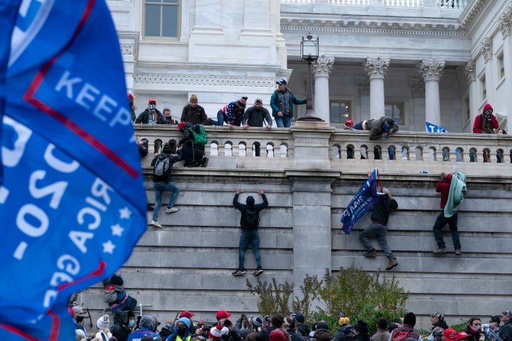 Supporters of President Donald Trump climb the west wall of the the U.S. Capitol on Wednesday, Jan. 6.