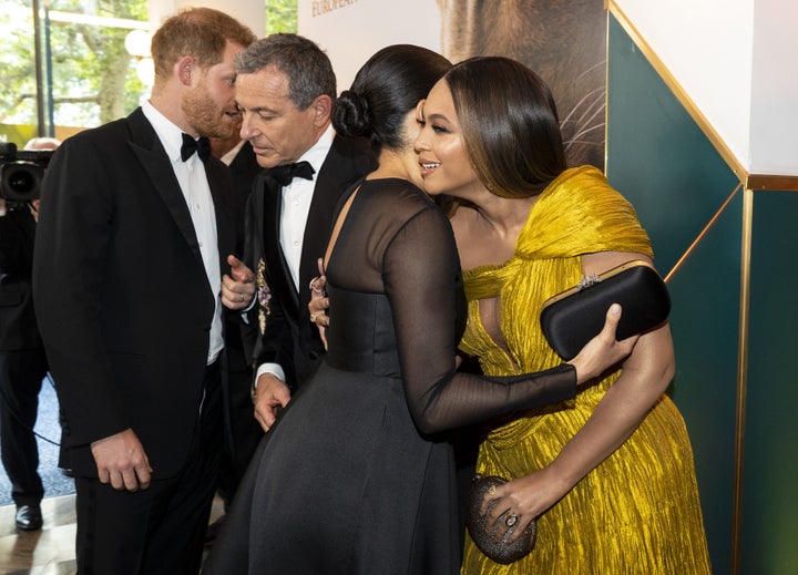 Meghan Markle greets Beyoncé as Prince Harry chats with Disney CEO Bob Iger at the London premiere of "The Lion King" on July 14, 2019.