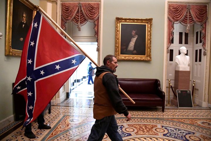 A Trump supporter carried a Confederate battle flag on the second floor of the U.S. Capitol near the entrance to the Senate after breaching security defenses.