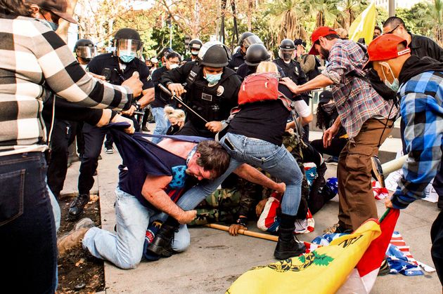 Supporters of President Donald Trump, who were protesting election results, and counter-protesters brawl outside Los Angeles police department headquarters in Los Angeles