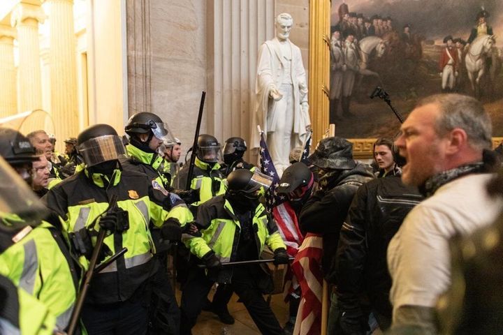 Pro-Trump rioters clash with police after storming the US Capitol.