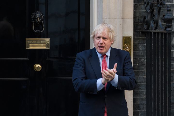 British Prime Minister Boris Johnson claps outside 10 Downing Street during the weekly 'Clap for our Carers' in May 2020.