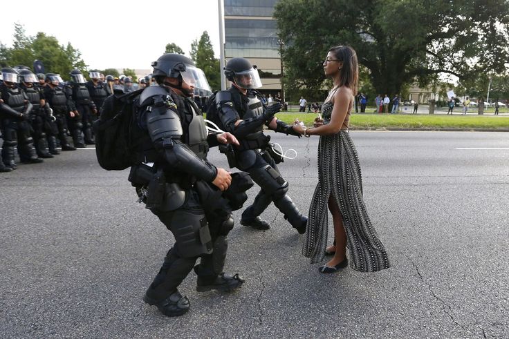 Activist Ieshia Evans stands her ground while offering her hands for arrest as she is charged by riot police during a protest against police brutality outside the Baton Rouge Police Department in Louisiana in July 2016. 