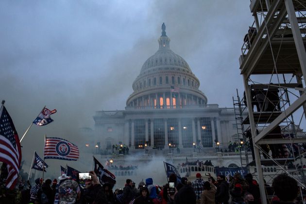 Security forces respond with tear gas after the U.S. President Donald Trump's supporters breached the...