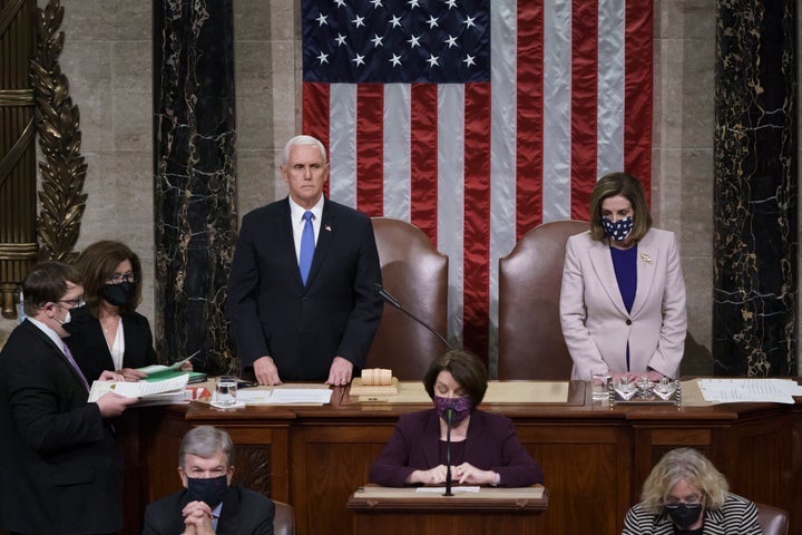 Vice President Mike Pence and Speaker of the House Nancy Pelosi read the final certification of Electoral College votes cast in November's presidential election on Thursday, January 7, 2021. 