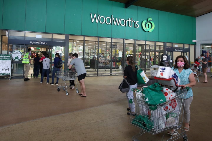 People stand in line outside a Woolworths at a southern suburb of Brisbane on January 08, 2021.