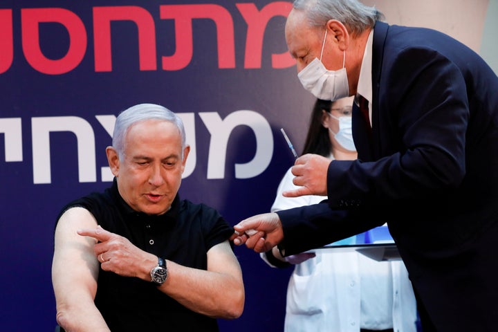 First in line: Israeli Prime Minister Benjamin Netanyahu gets ready to receive a coronavirus vaccine at Sheba Medical Center 