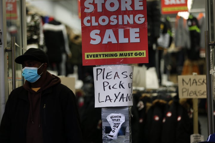 Sale signs are displayed in the window of a business in Brooklyn, New York, on Dec. 1, 2020. Businesses continue to struggle