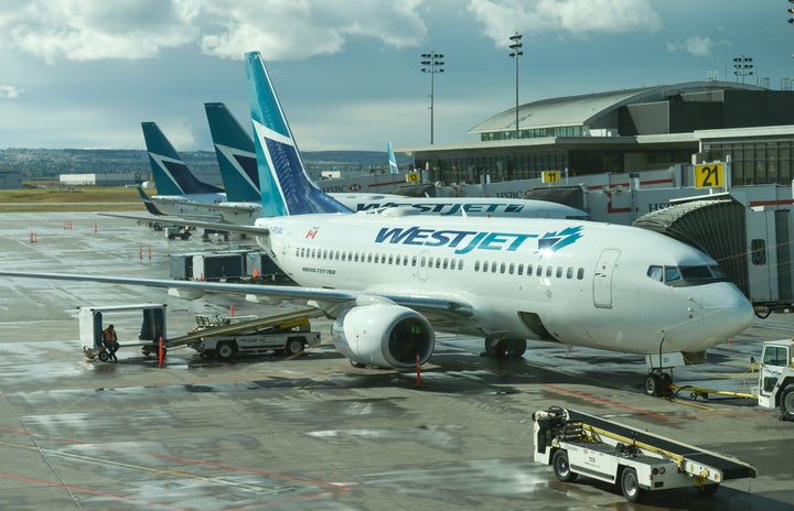 A view of WestJet planes at Calgary International Airport, Mon. Sept. 10, 2018. WestJet is laying off staff in the wake of new federal COVID-19 testing requirements for Canada-bound passengers.