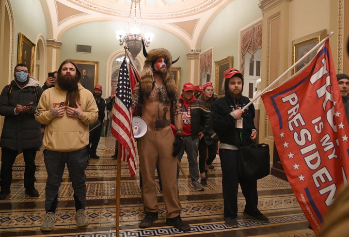 Trump supporters storm through the Capitol on Wednesday after breaching security and breaking through windows and doors while