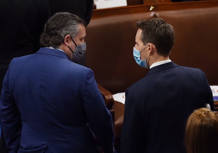 Sen. Ted Cruz (R-Texas), speaks with colleague Sen. Josh Hawley (R-Mo.) during a joint session of Congress to count the electoral votes at the U.S. Capitol on Jan. 6.