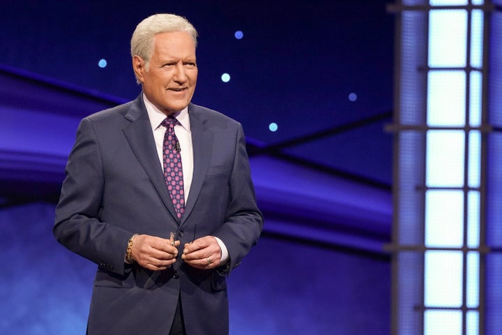 Alex Trebek is seen hosting Jeopardy's "Greatest of All Time" tournament.