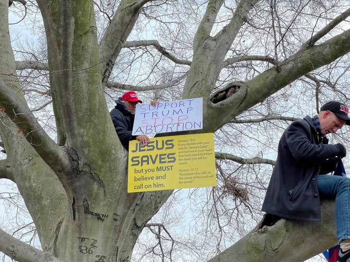 A Trump supporter displays a "Jesus Saves" sign&nbsp;at a rally at the U.S. Capitol on Jan. 6.