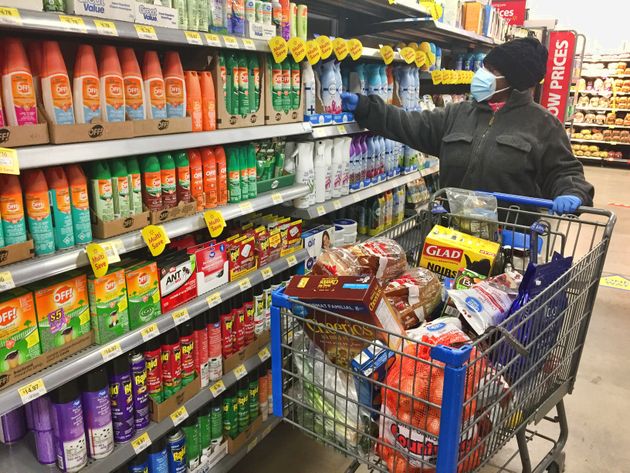 Woman wearing a face mask and rubber gloves while shopping at a Walmart store in Toronto on