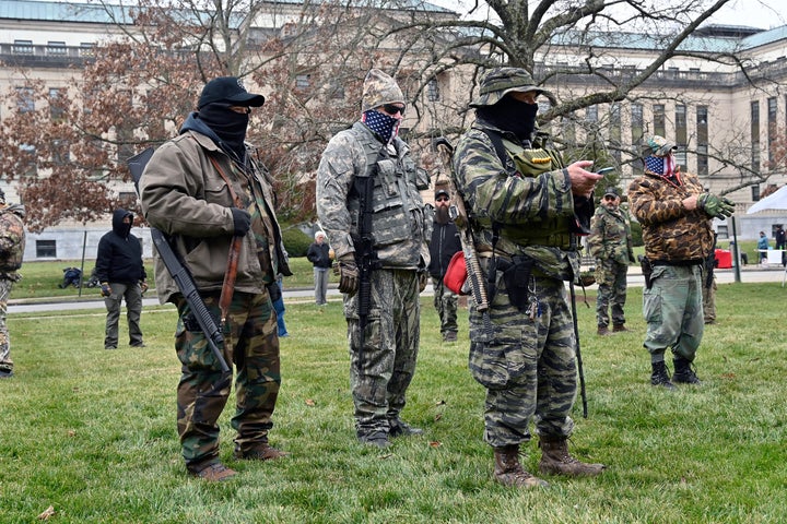 A group of armed protesters listen to speakers during a rally on the lawn of the Kentucky State Capitol in Frankfort.