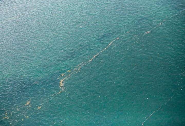 This aerial shot taken from an Indonesian Air Force plane shows oil slick and debris floating on the water near the site where Sriwijaya Air passenger jet is thought to have crashed near Jakarta, Indonesia.