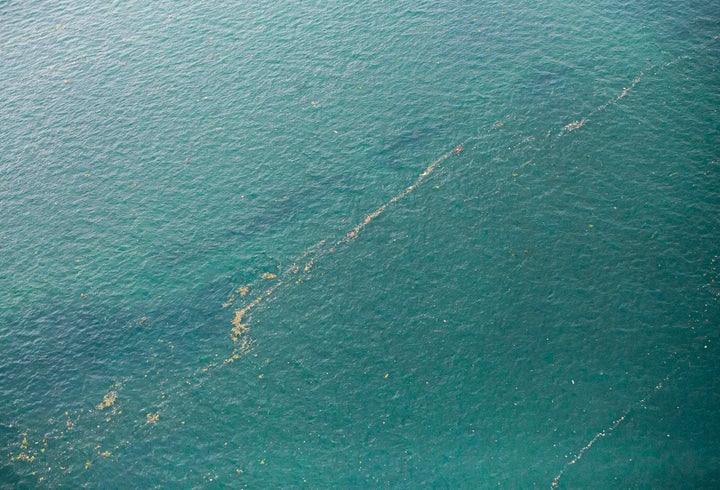 This aerial shot taken from an Indonesian Air Force plane shows oil slick and debris floating on the water near the site where Sriwijaya Air passenger jet is thought to have crashed near Jakarta, Indonesia.