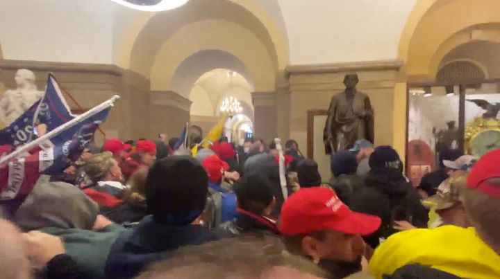 Supporters of President Donald Trump storm the Capitol building in Washington, U.S., January 6, 2021 in this screen grab obtained from a social media video. (Brendan Gutenschwager/via REUTERS)