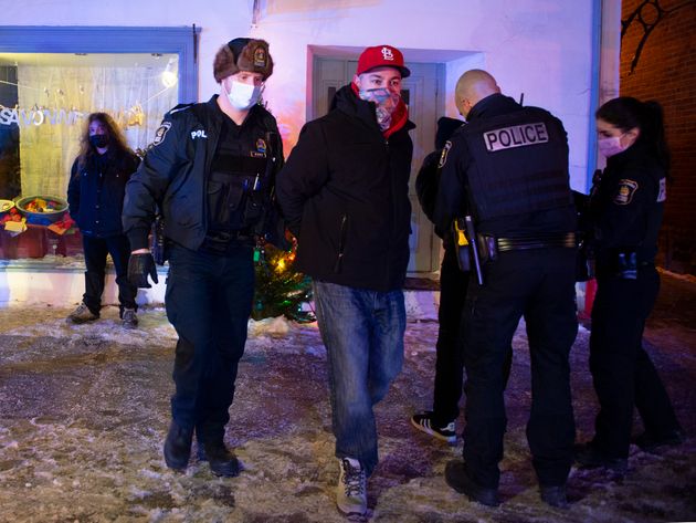 A man is arrested by Quebec City police after 8 p.m. as a curfew begins in the province of Quebec to...