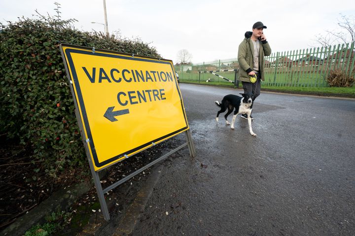 A member of the public passes a COVID-19 vaccination centre at Hyde Leisure Centre in Manchester, England, Friday Jan. 8, 2021. Mass vaccination hubs are due to begin operating next week. (AP Photo/Jon Super)