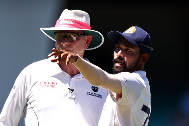 Mohammed Siraj of India stops play to make a formal complaint to Umpire Paul Reiffel about some spectators in the bay behind his fielding position during day four of the Third Test match in the series between Australia and India at Sydney Cricket Ground on January 10, 2021 in Sydney, Australia.