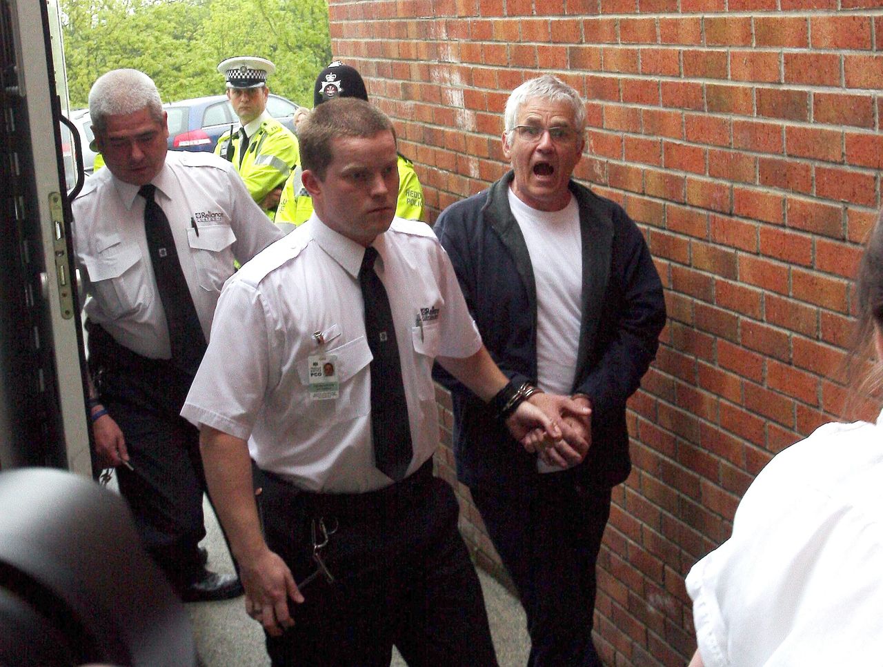 John Cooper (right) pictured arriving at Haverfordwest Magistrates Court in Wales in May 2009 