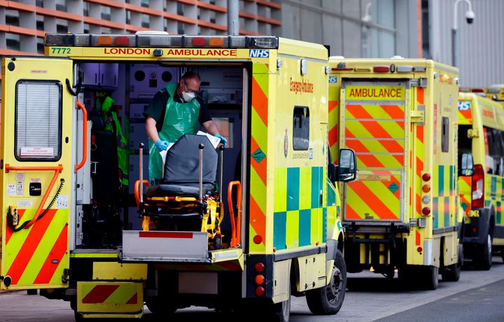 A member of ambulance crew puts a stretcher back into and empty ambulance at the Royal Free Hospital in London.