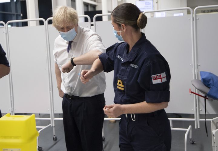 Prime Minister Boris Johnson at Ashton Gate Stadium in Bristol talks to the Navy team training to vaccinate during a visit to one of the seven mass vaccination centres now opened to the general public