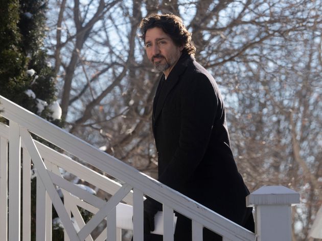 Prime Minister Justin Trudeau walks up the front steps of Rideau Cottage following a news conference...