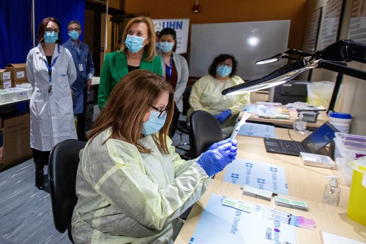 Pharmacy technician supervisor Tamara Booth Rumsey prepares a Pfizer-BioNTech coronavirus vaccine at The Michener Institute, in Toronto, Jan. 4, 2021. 