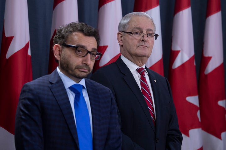 Omar Alghabra and Marc Garneau listen to a question during a news conference on the Iran plane crash on Jan. 15, 2020 in Ottawa.