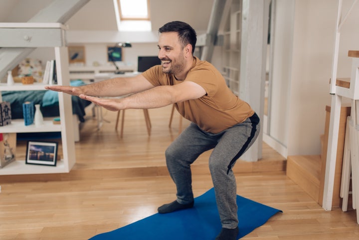 Foto de Young women doing fitness exercises on the butt in the bright  studio on yoga mats do Stock