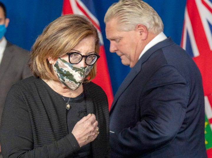 Ontario's associate chief medical officer of health Dr. Barbara Yaffe passes Premier Doug Ford at a press conference in Toronto Jan. 8, 2021.