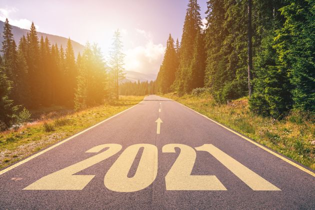 Empty asphalt road and New year 2021 concept. Driving on an empty road in the mountains to upcoming 2021 and leaving behind old 2020. Concept for success and passing time.