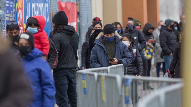 Shoppers line up outside a Scarborough, Ont., Walmart Superstore in this undated file photo. Ontario...