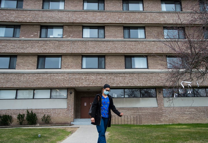 A health-care worker leaves after finishing her shift for the day at the Eatonville Care Centre in Toronto on April 24, 2020. 